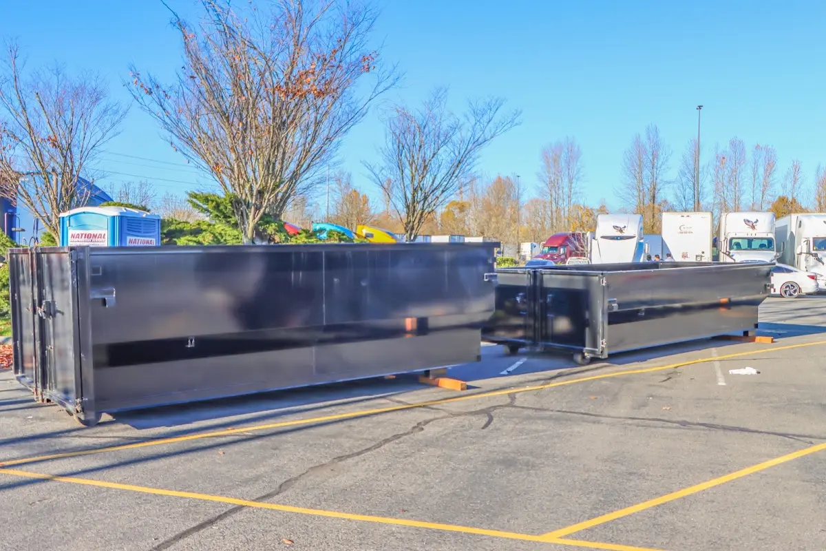 Professional dumpster rental service with roll-off container on residential driveway in Prineville
